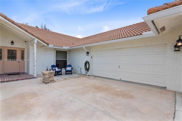 exterior space featuring a patio area and a garage