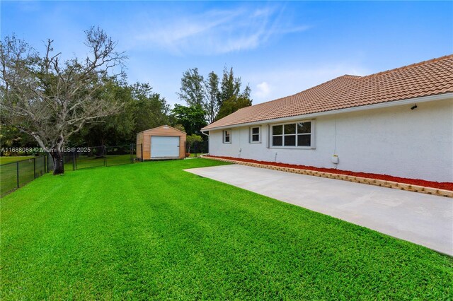 view of yard featuring a shed and a patio area