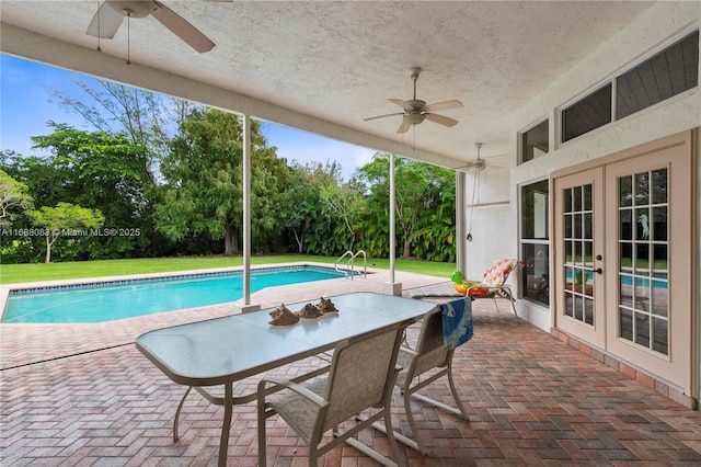 view of swimming pool featuring french doors, ceiling fan, and a patio area