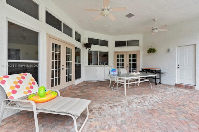 view of patio / terrace with ceiling fan and french doors