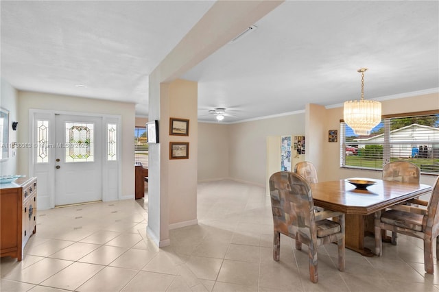 dining space featuring ceiling fan with notable chandelier, light tile patterned floors, and ornamental molding