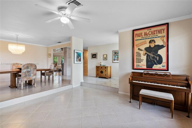 interior space featuring light tile patterned floors, ceiling fan with notable chandelier, and crown molding