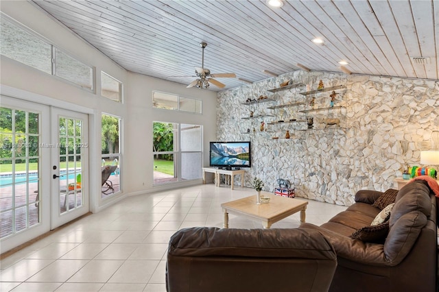 living room featuring ceiling fan, french doors, light tile patterned flooring, and wood ceiling