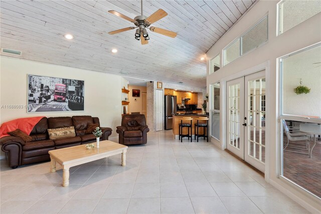 tiled living room with ceiling fan, wooden ceiling, and french doors