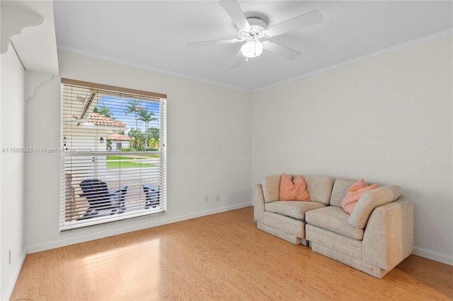 sitting room featuring light hardwood / wood-style floors, ceiling fan, and ornamental molding