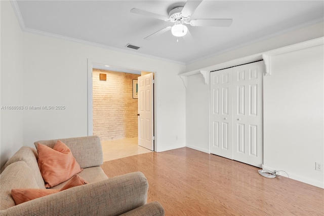 2940 SW 155th Ln, Davie, FL 33331 - living area featuring crown molding, wood finished floors, ceiling fan, and brick wall