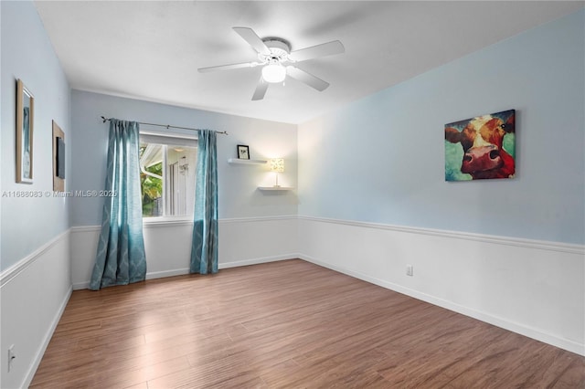 spare room featuring wood-type flooring and ceiling fan