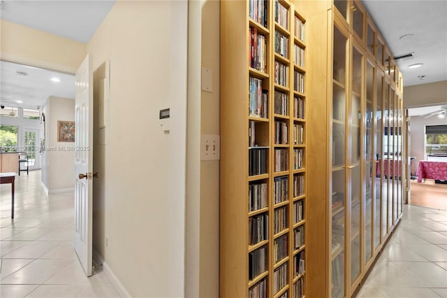 corridor featuring light tile patterned floors