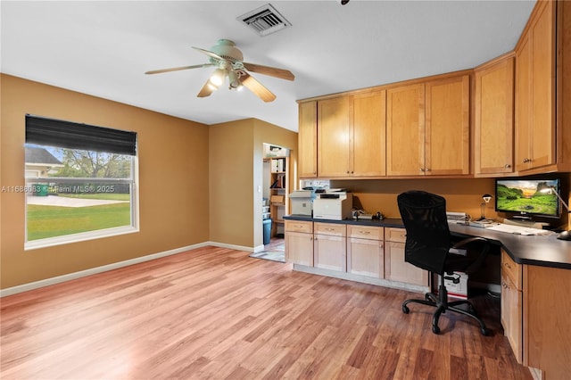 office featuring ceiling fan, light hardwood / wood-style floors, and built in desk