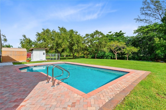 view of swimming pool featuring a yard, a patio, and a storage unit