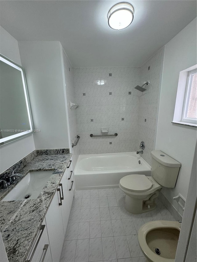 full bathroom featuring toilet, tiled shower / bath combo, and vanity