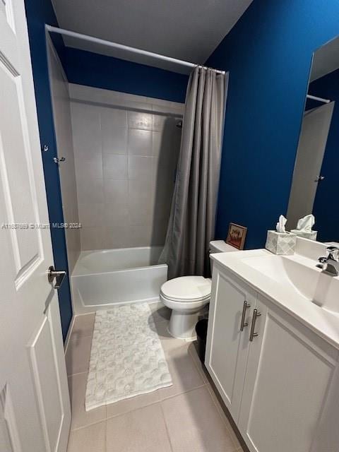 full bathroom featuring toilet, shower / bath combo, vanity, and tile patterned floors