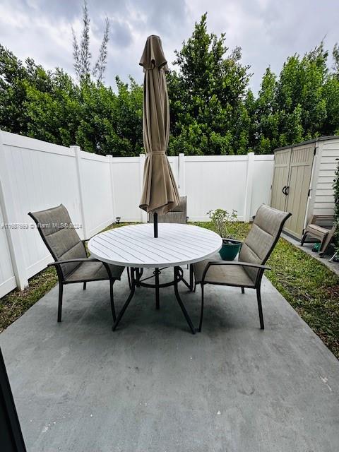 view of patio / terrace featuring a storage shed