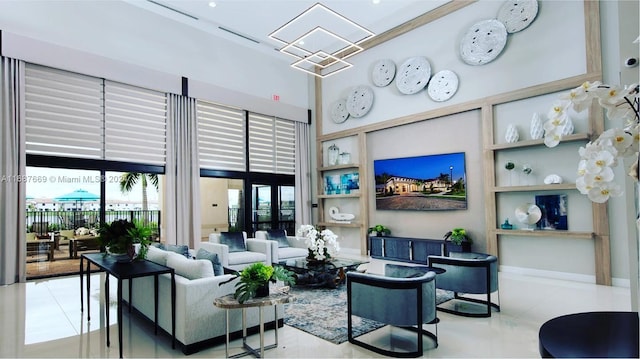 living room with a high ceiling, french doors, and light tile patterned floors