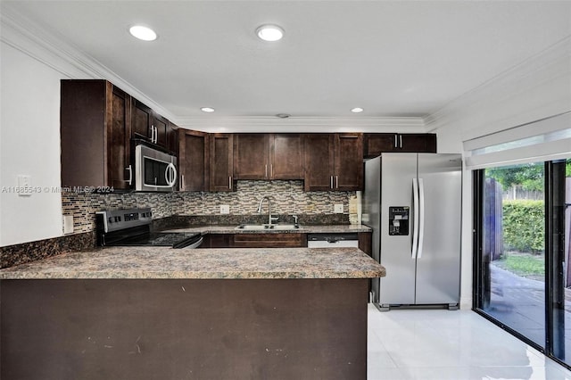 kitchen featuring tasteful backsplash, kitchen peninsula, appliances with stainless steel finishes, and sink