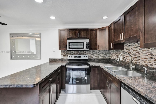 kitchen featuring dark brown cabinets, sink, appliances with stainless steel finishes, and tasteful backsplash