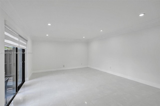 unfurnished room with crown molding