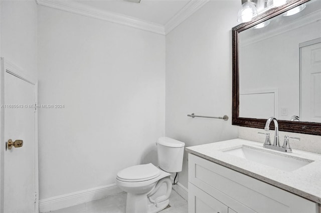 bathroom with toilet, vanity, tile patterned floors, and crown molding