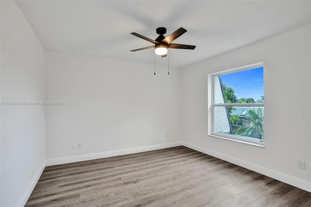 spare room with hardwood / wood-style floors and ceiling fan