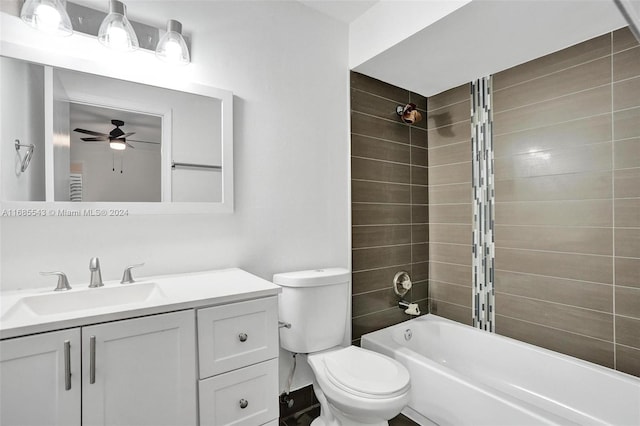 full bathroom with ceiling fan, vanity, toilet, and tiled shower / bath