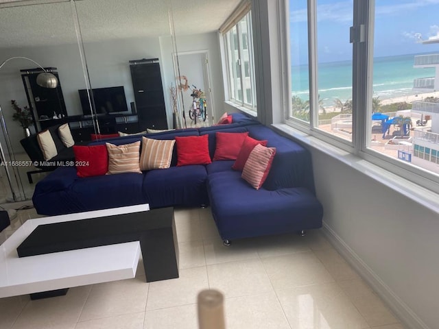 5401 Collins Ave Unit 412, Miami Beach, FL 33140 - tiled living room featuring a water view and a textured ceiling