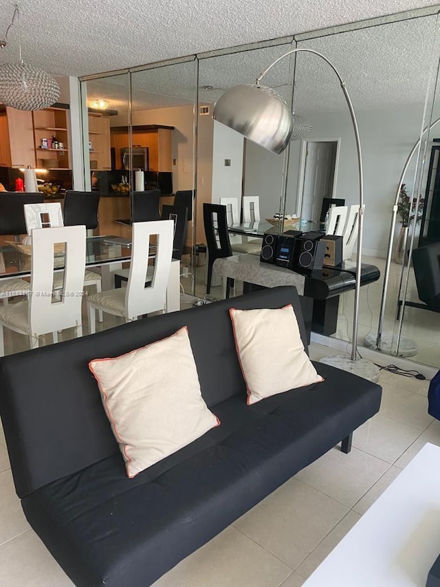 5401 Collins Ave Unit 412, Miami Beach, FL 33140 - tiled living area featuring a textured ceiling