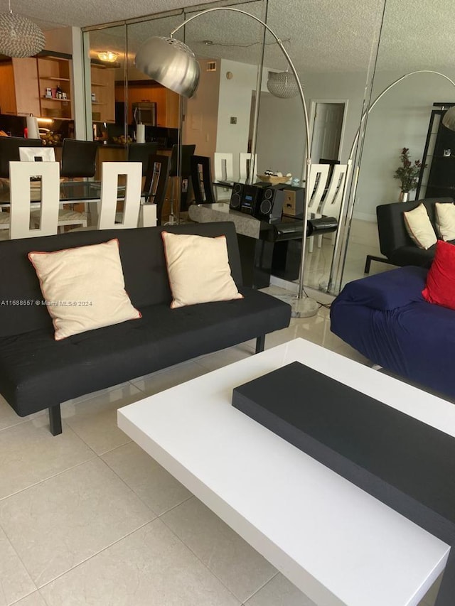5401 Collins Ave Unit 412, Miami Beach, FL 33140 - living room featuring a textured ceiling and tile patterned floors