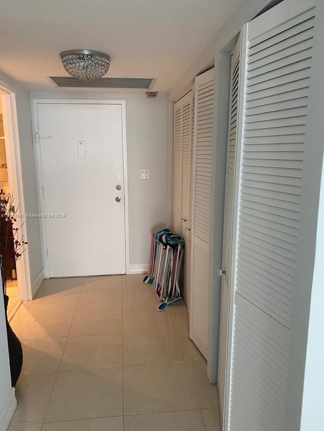 corridor with light tile patterned floors