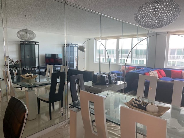 dining room with a textured ceiling and tile patterned flooring