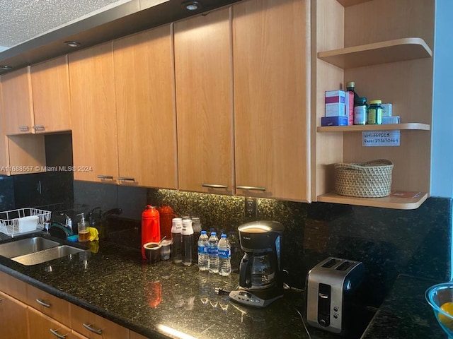 5401 Collins Ave Unit 412, Miami Beach, FL 33140 - kitchen featuring open shelves, decorative backsplash, and dark stone countertops