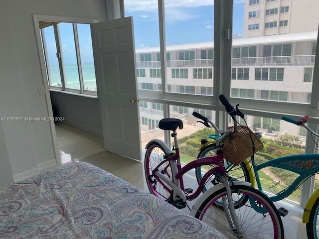 bedroom featuring multiple windows and a water view