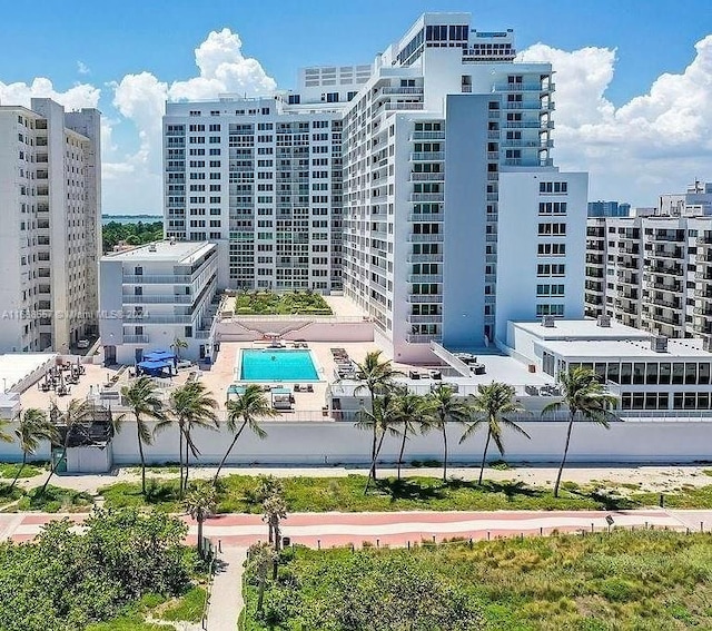 view of building exterior with a community pool