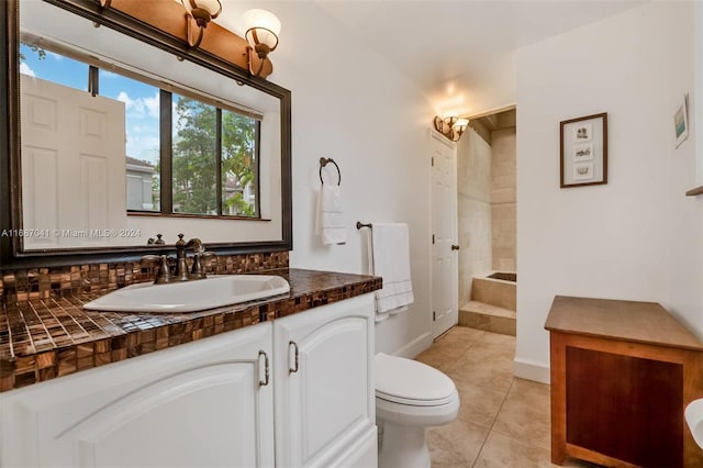 bathroom featuring toilet, vanity, and tile patterned flooring