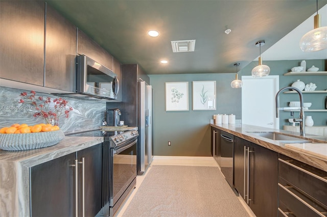 kitchen with appliances with stainless steel finishes, sink, dark brown cabinetry, and hanging light fixtures