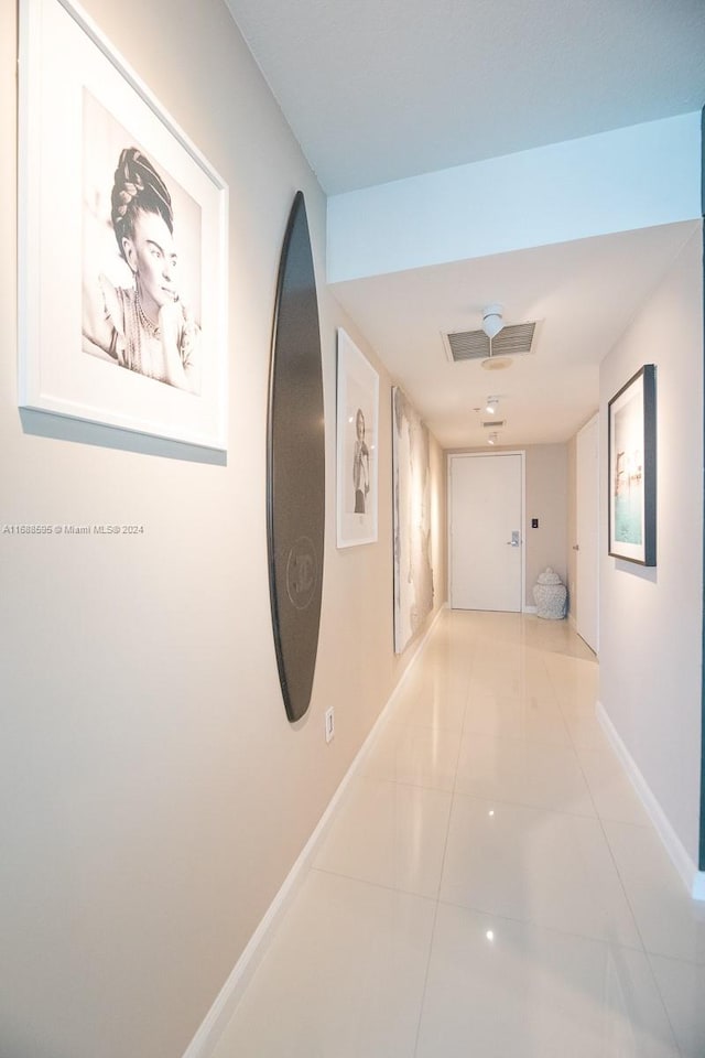 hall featuring light tile patterned flooring