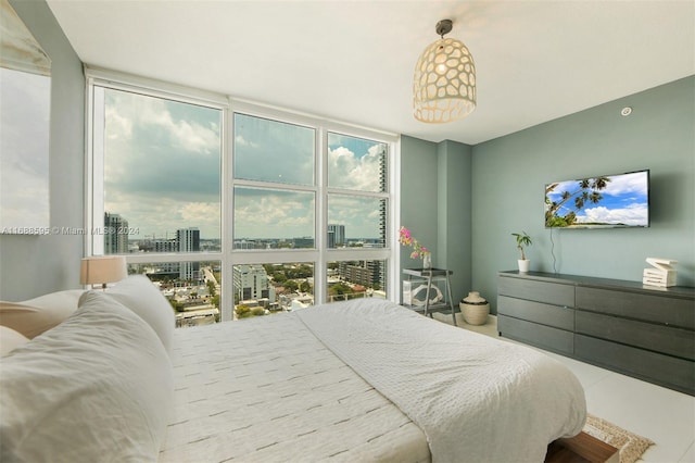 bedroom featuring multiple windows and floor to ceiling windows