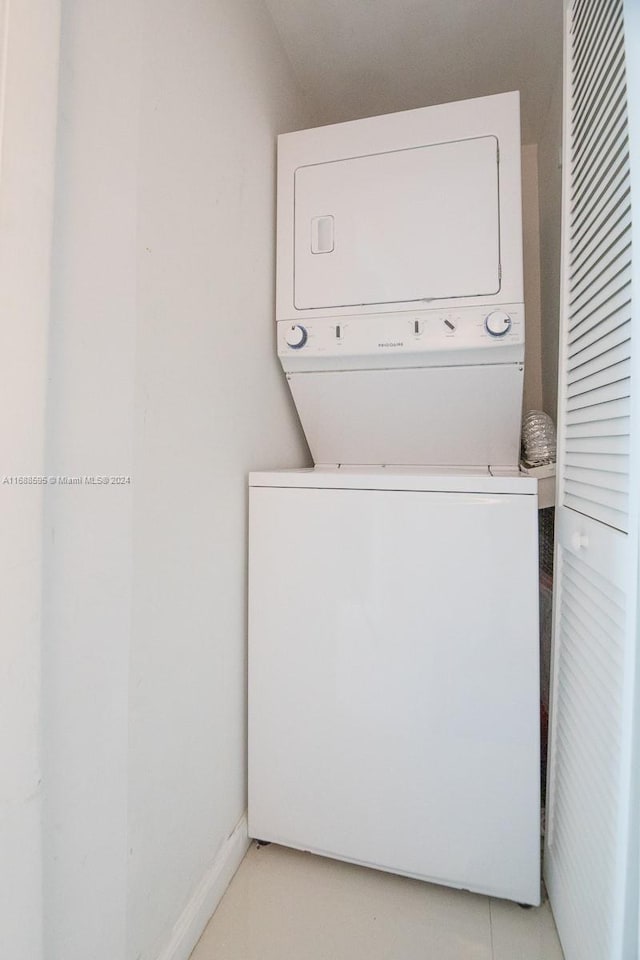 laundry area with stacked washer / dryer