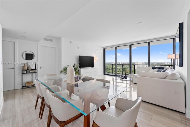 1451 Brickell Ave Unit 2205, Miami, FL 33131 - dining room with a wall of windows and light wood-style floors