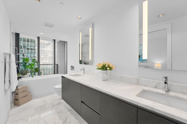 1451 Brickell Ave Unit 2205, Miami, FL 33131 - bathroom featuring a freestanding bath, marble finish floors, double vanity, and recessed lighting