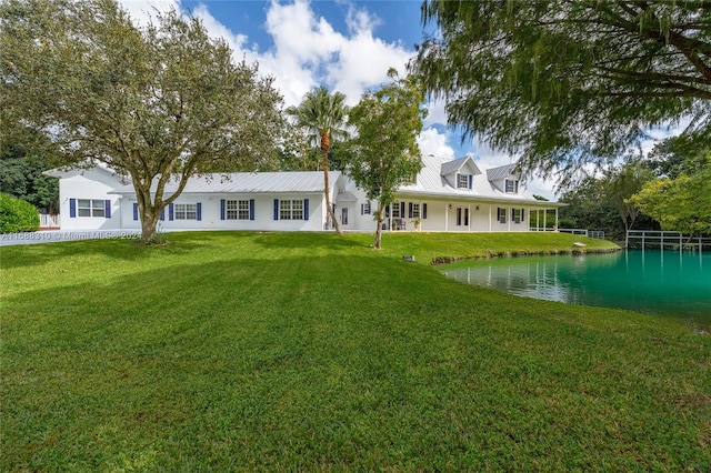 view of front of property with a water view and a front yard