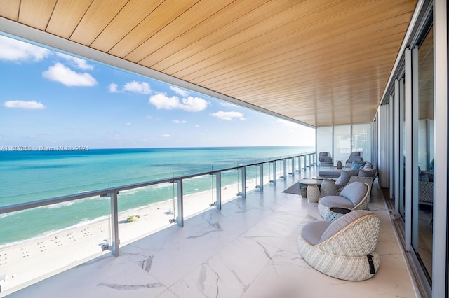 balcony with a view of the beach and a water view