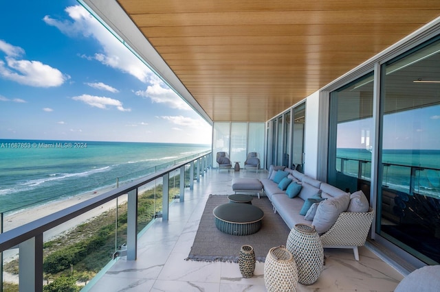 balcony with a beach view, a water view, and an outdoor hangout area