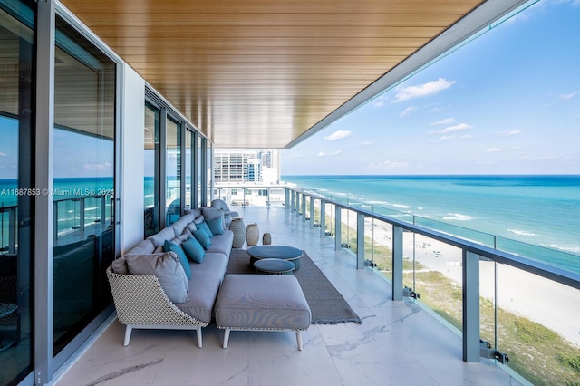 balcony with a beach view and a water view