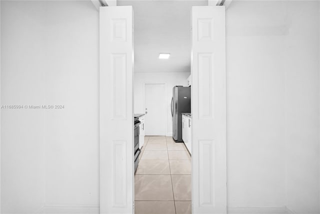 hallway with light tile patterned floors