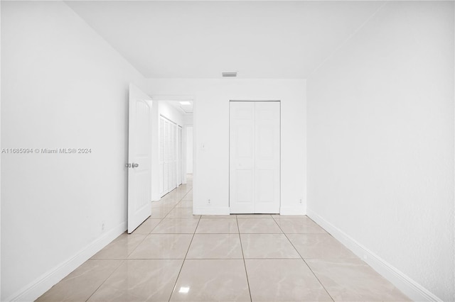 hallway featuring light tile patterned floors