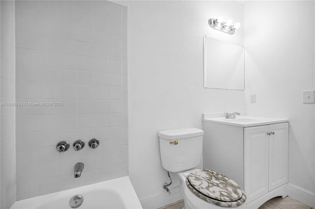 full bathroom with toilet, vanity, and tiled shower / bath