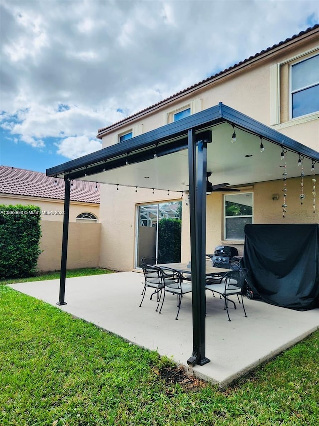 rear view of property with a patio and a lawn