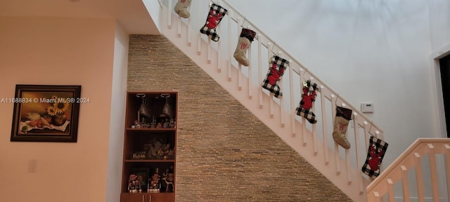 hall featuring a high ceiling and built in shelves