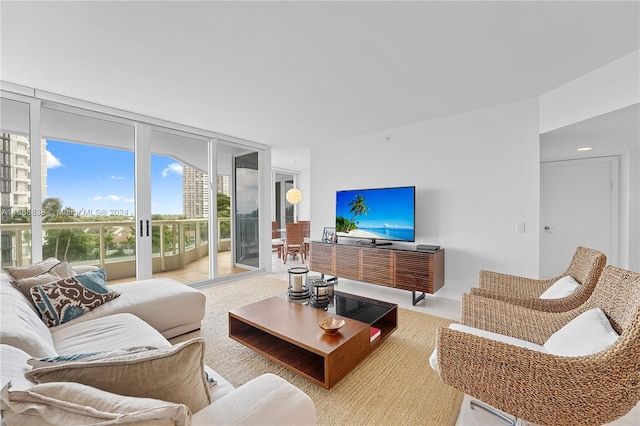 living room featuring floor to ceiling windows and light carpet