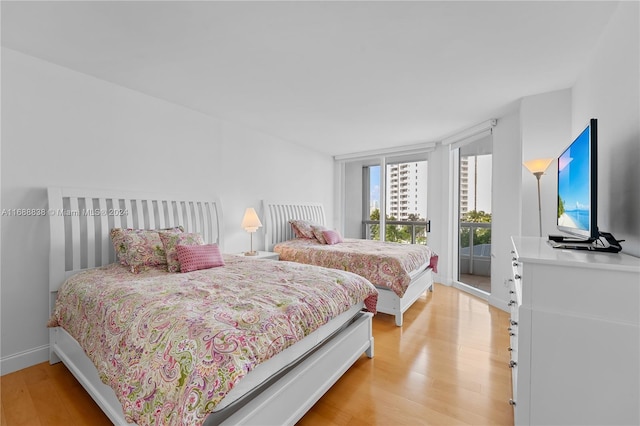 bedroom featuring access to outside and light hardwood / wood-style floors